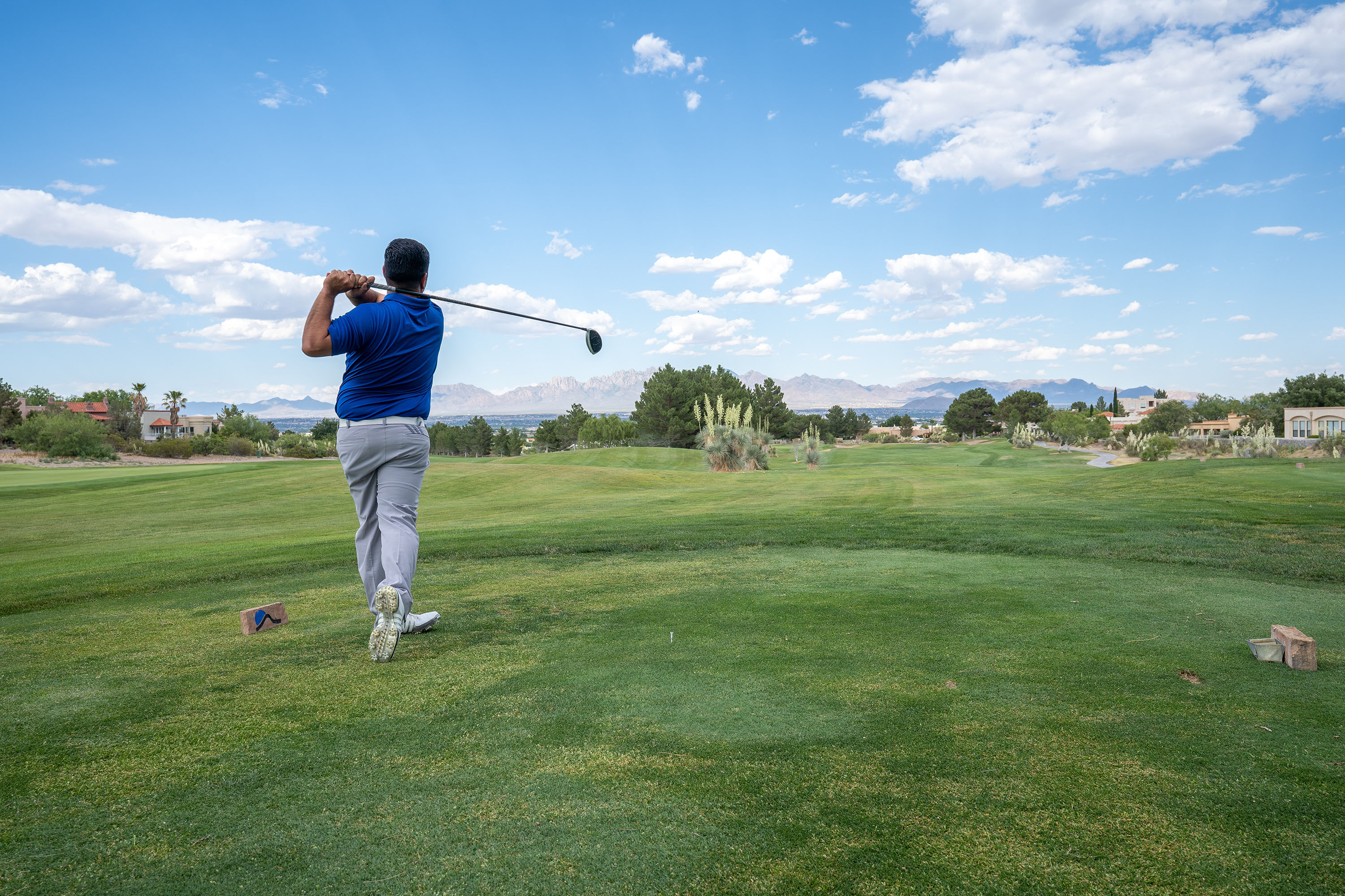 Man golfing at a club.