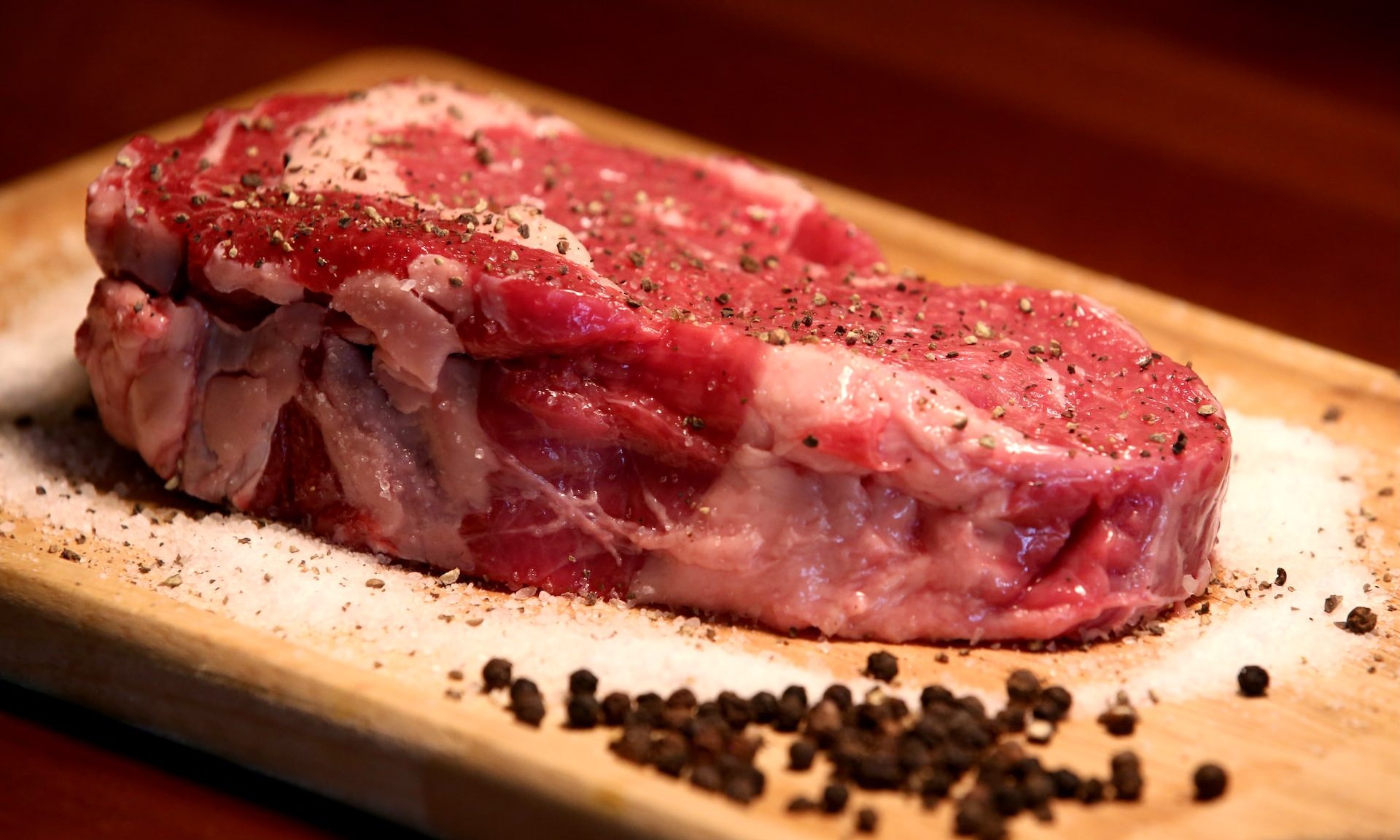 Raw steak on cutting board