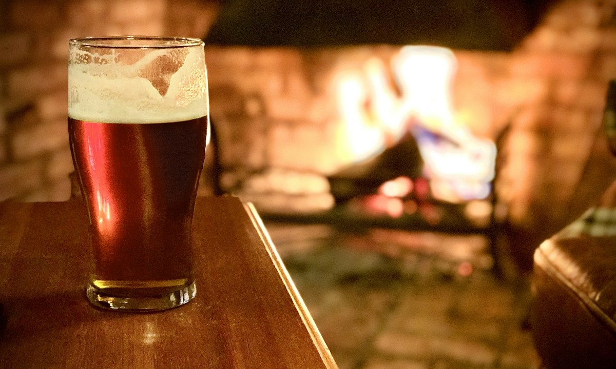Beer with a fireplace in the background