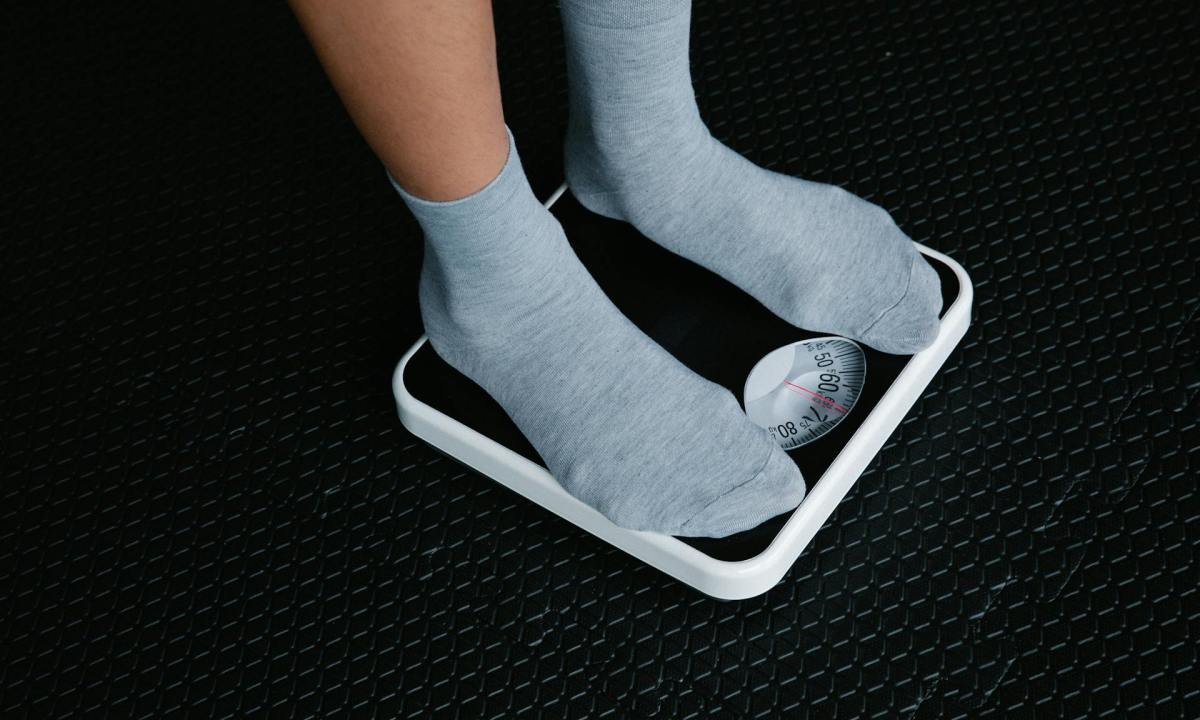 Standing on a scale weighing body weight