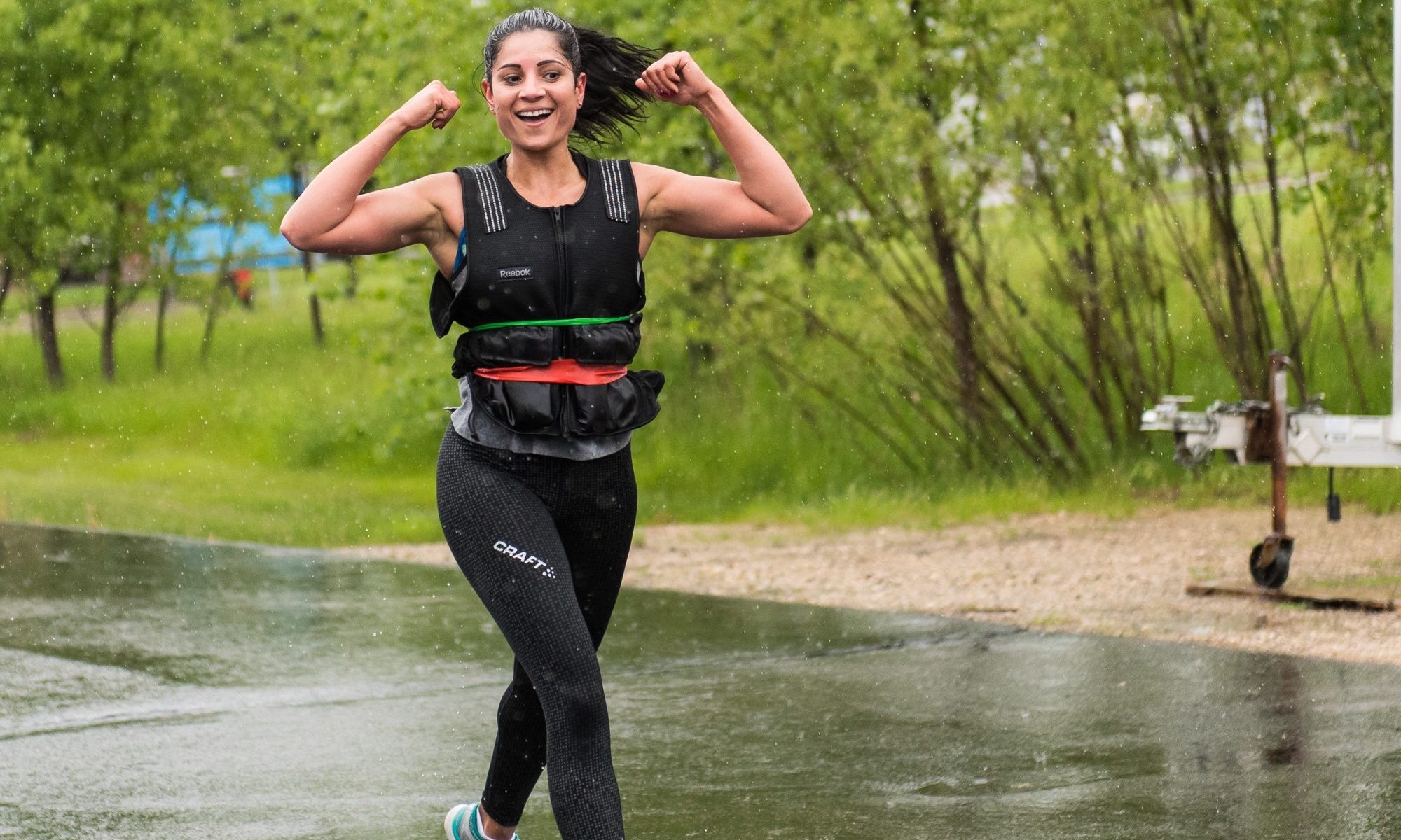 woman wearing weighted vest happy walking working out outdoors